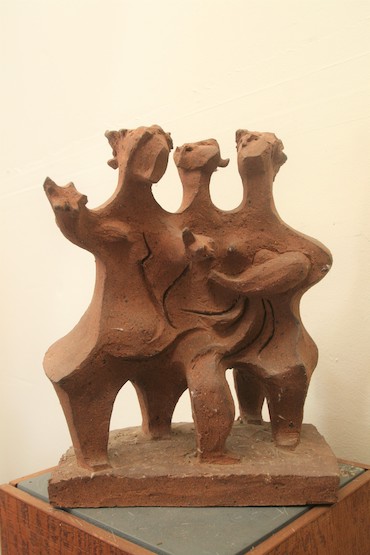 (three figures, arms outreached)