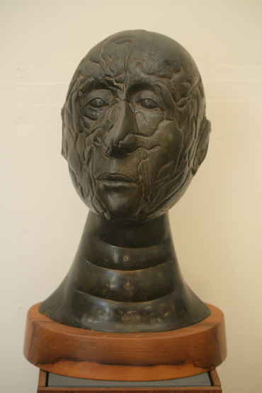 (man's
bust with wavy lines grooved into face)